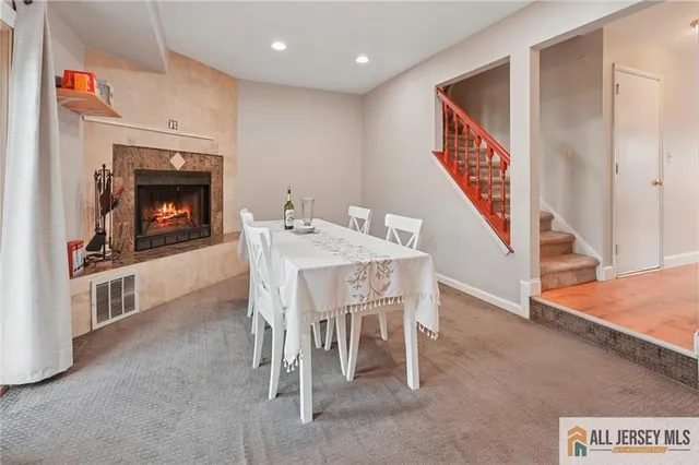 a dining room with furniture and a fireplace