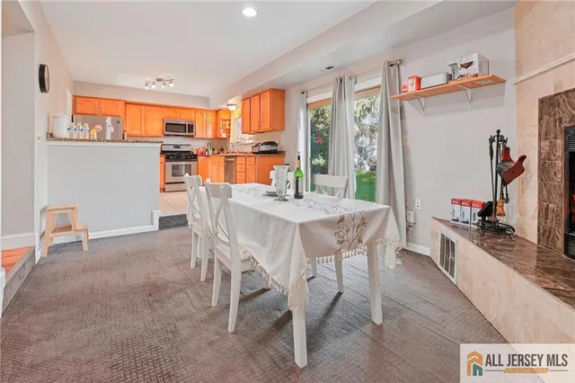 a dining room with furniture and a kitchen view