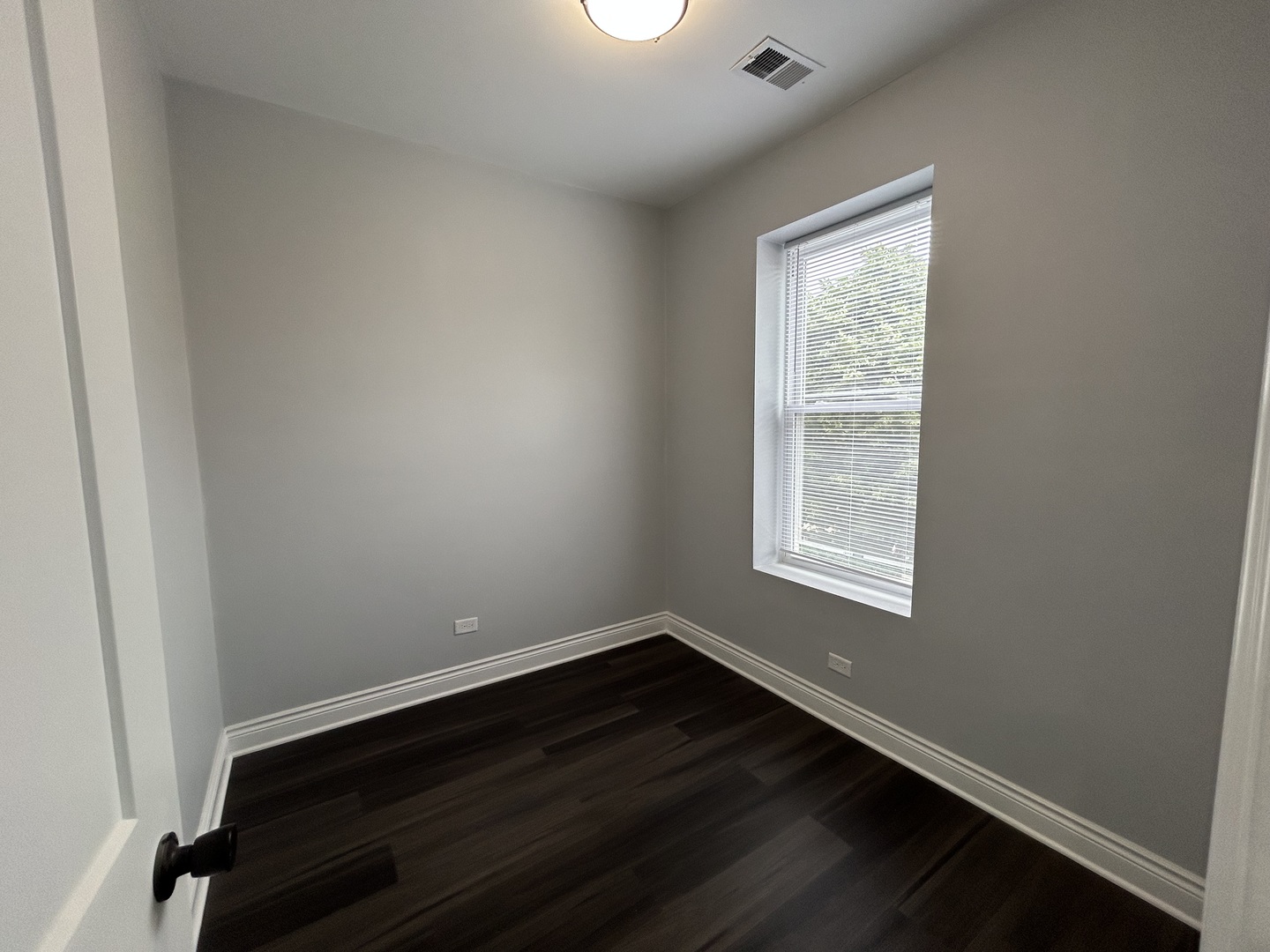 7940 South Carpenter Street, Unit 2 Chicago, IL 60620 - Photo 33 of 34 an empty room with wooden floor and windows