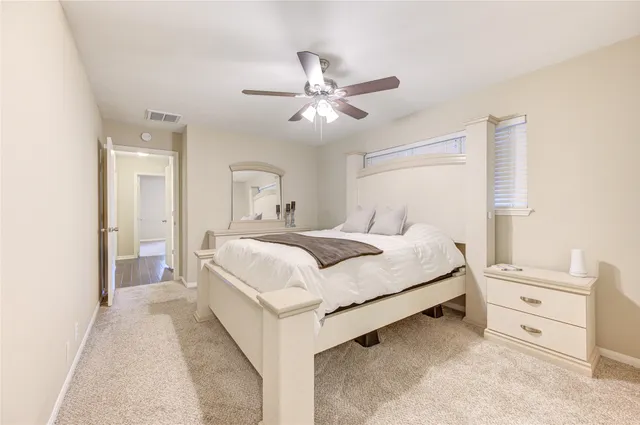 a bedroom with a bed and ceiling fan