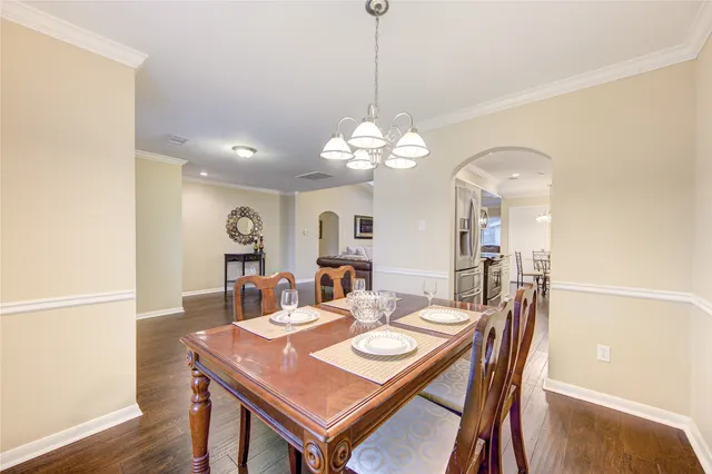 a view of a dining room with a table and chairs