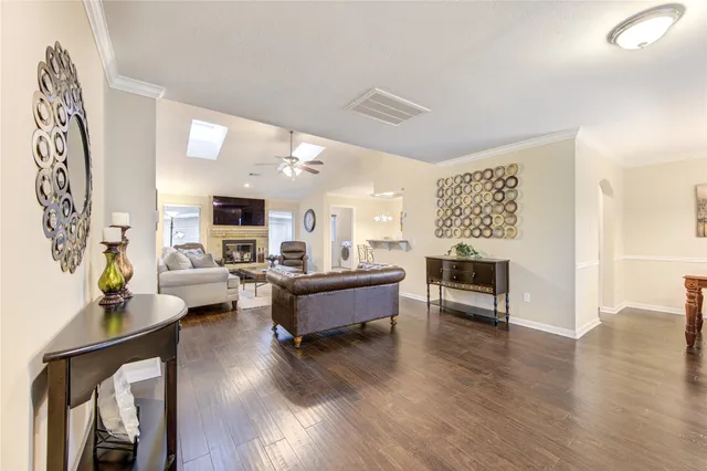 a living room with fireplace furniture and a wooden floor