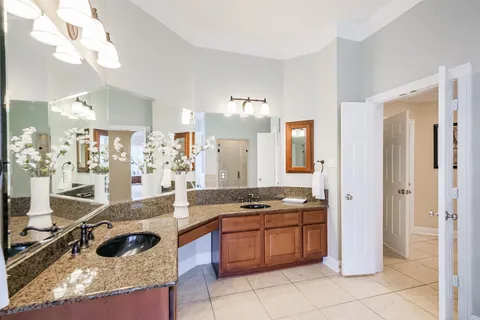 a kitchen with granite countertop a stove a sink a refrigerator and a counter top space
