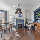 a dining room with furniture window and wooden floor