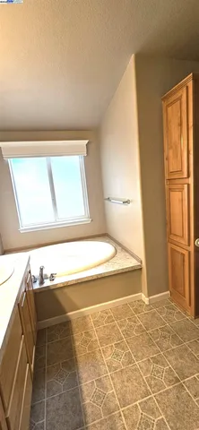 a view of a kitchen with wooden floor and a window