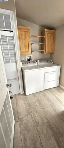 a view of kitchen with granite countertop cabinets and window