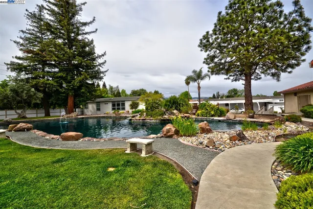 a swimming pool with outdoor seating and yard