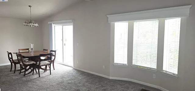 a view of a dining room with furniture and window