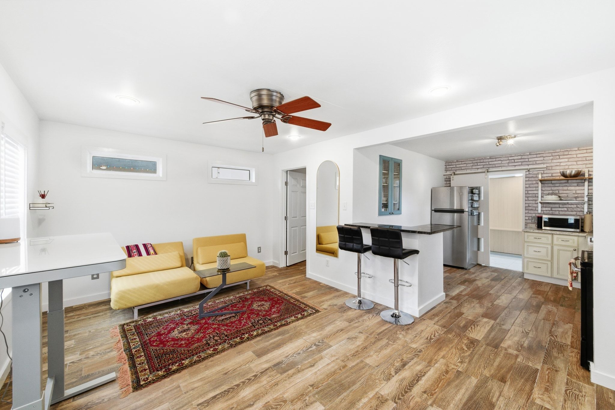 a living room with furniture and wooden floor