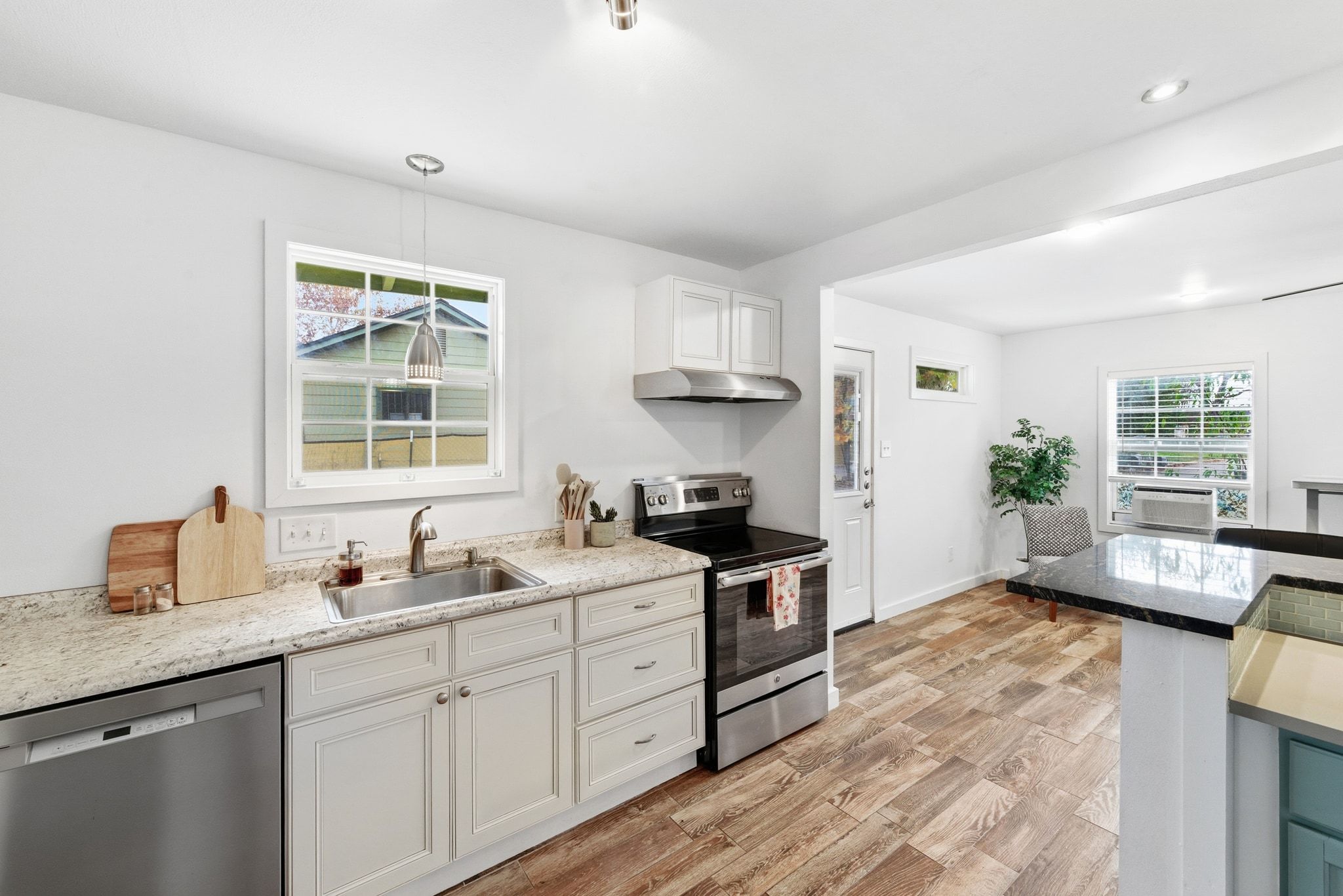 1706 Riverview Street, Unit A Austin, TX 78702 - Photo 12 of 23 a kitchen with granite countertop a sink stove and cabinets
