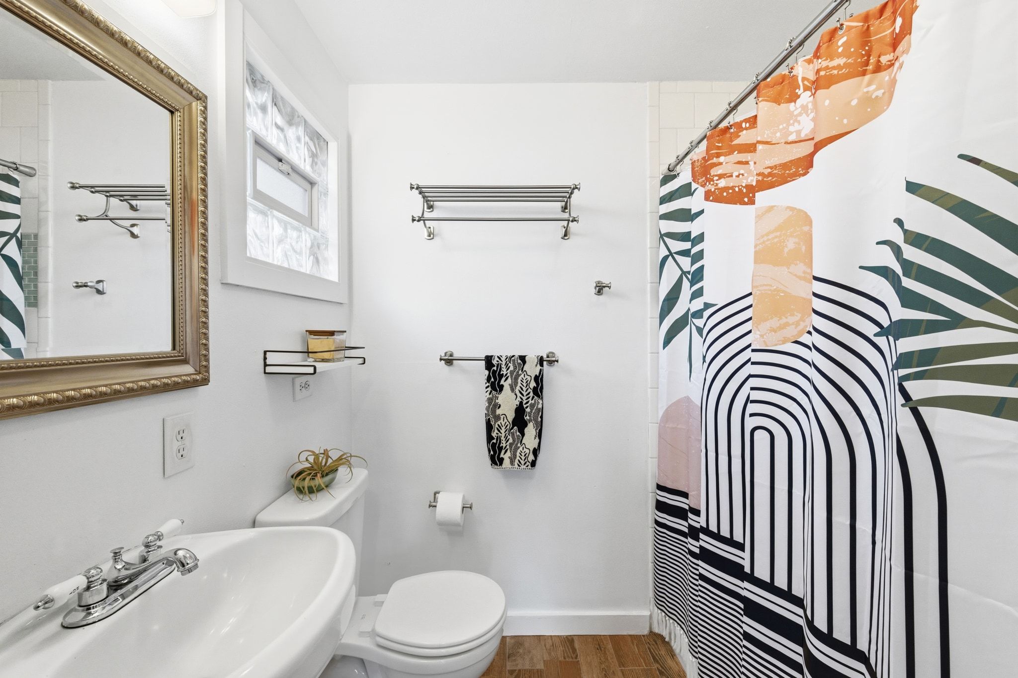 1706 Riverview Street, Unit A Austin, TX 78702 - Photo 16 of 23 a bathroom with a sink a toilet and shower curtain