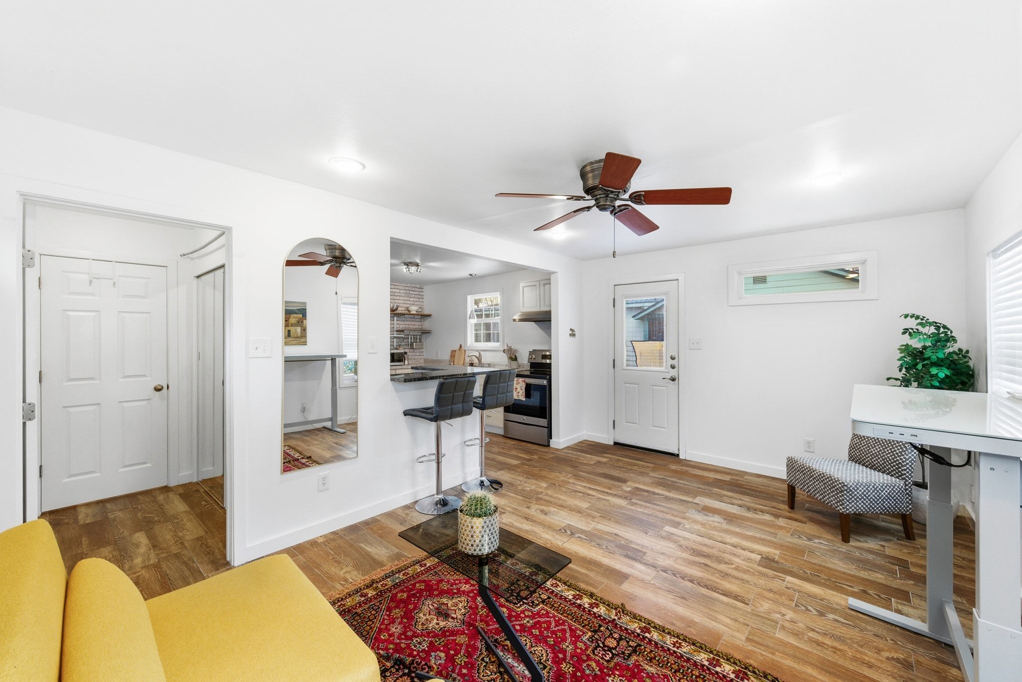 1706 Riverview Street, Unit A Austin, TX 78702 - Photo 2 of 23 a living room with furniture and a chandelier