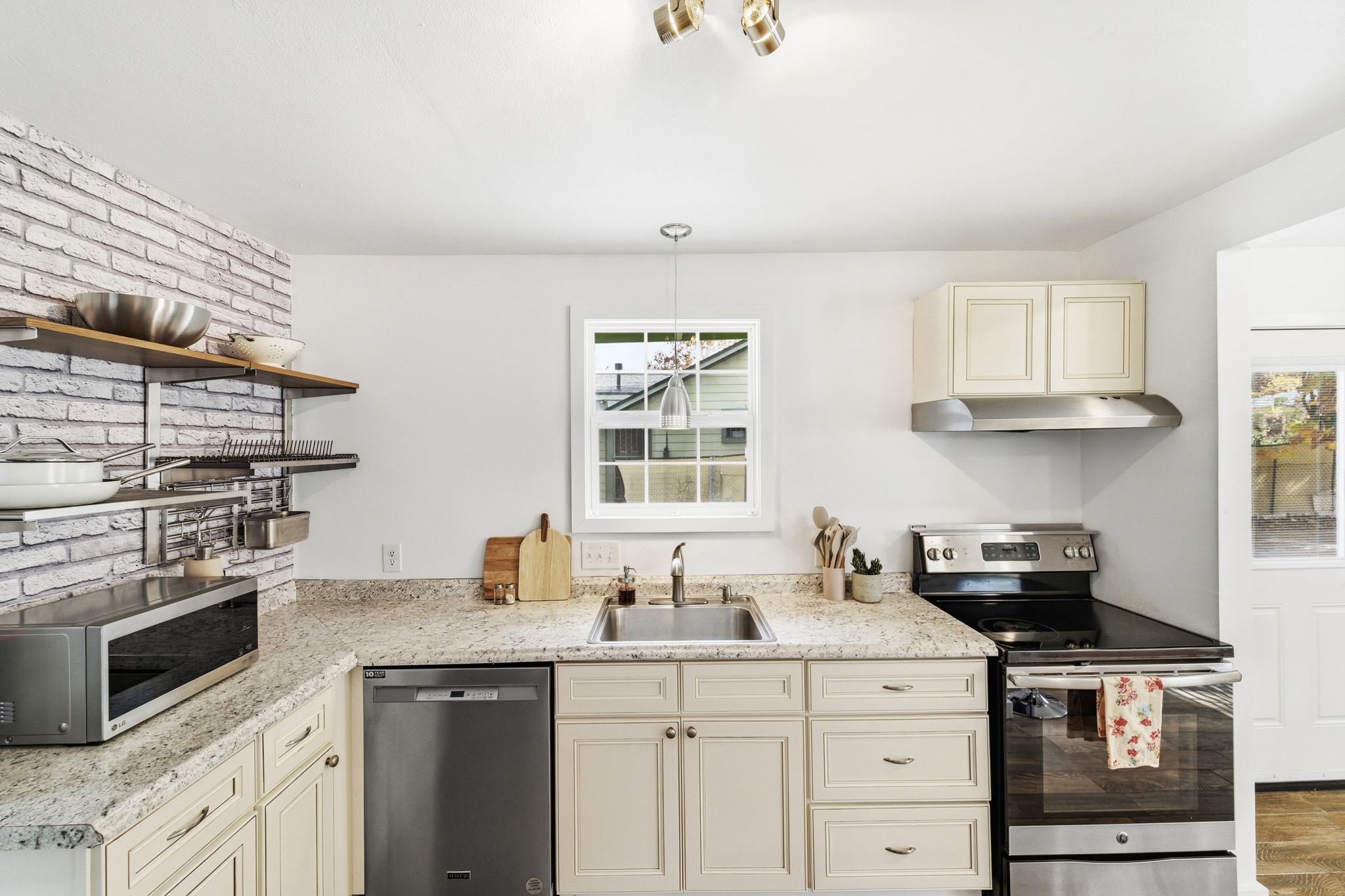 1706 Riverview Street, Unit A Austin, TX 78702 - Photo 5 of 23 a kitchen with stainless steel appliances a stove and a sink
