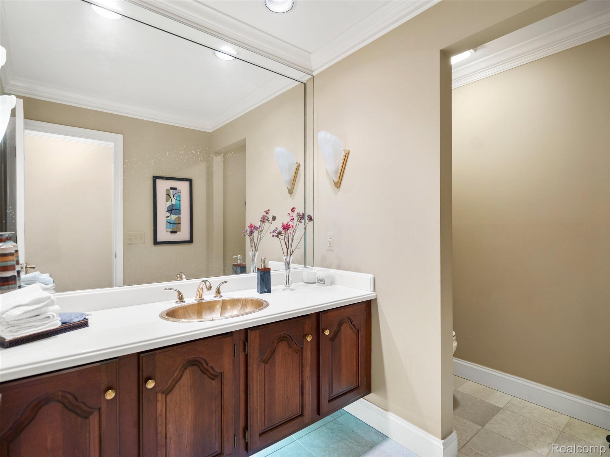 5724 Murfield Drive Rochester, MI 48306 - Photo 67 of 99 Bathroom with crown molding, vanity, and light tile patterned flooring