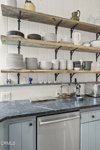 a kitchen with lots of counter space cabinets and a wooden floor
