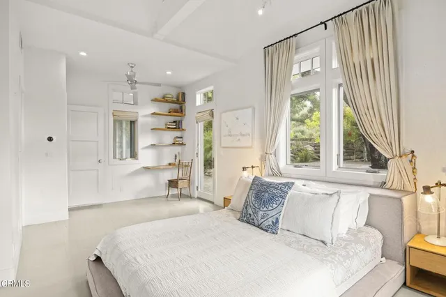 a bedroom with a large bed and a window