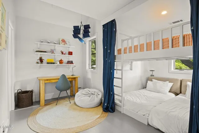 a bedroom with a bed a couch and dresser