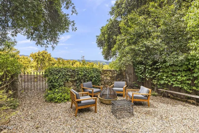 a backyard of a house with table and chairs