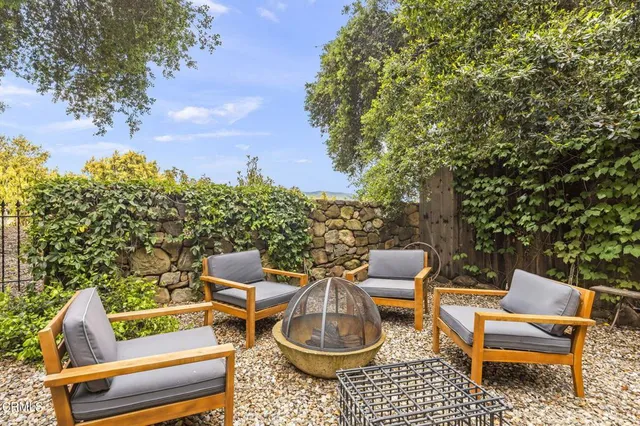 a backyard of a house with table and chairs