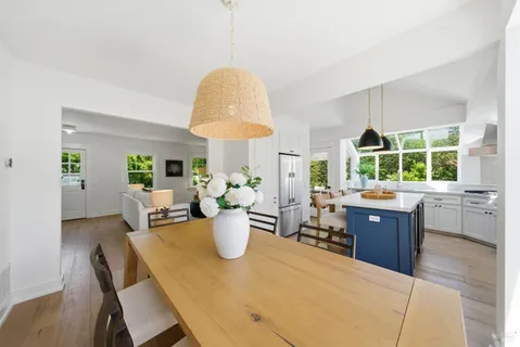 a view of a dining room with a table and chairs