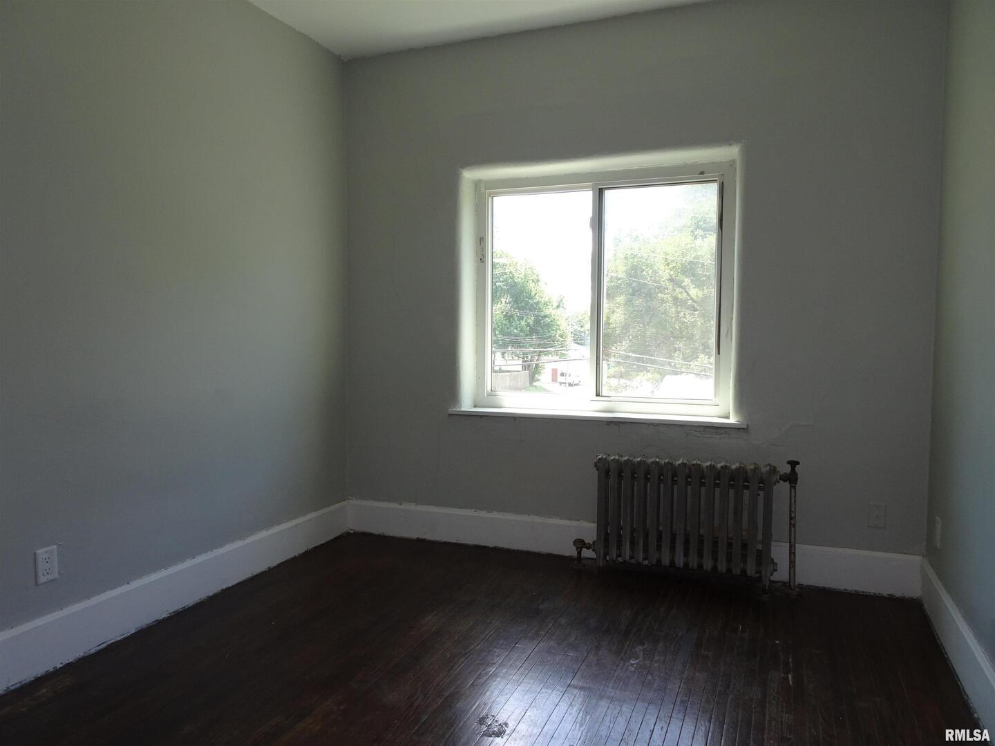 1930 9th Street Rock Island, IL 61201 - Photo 12 of 17 an empty room with wooden floor and windows