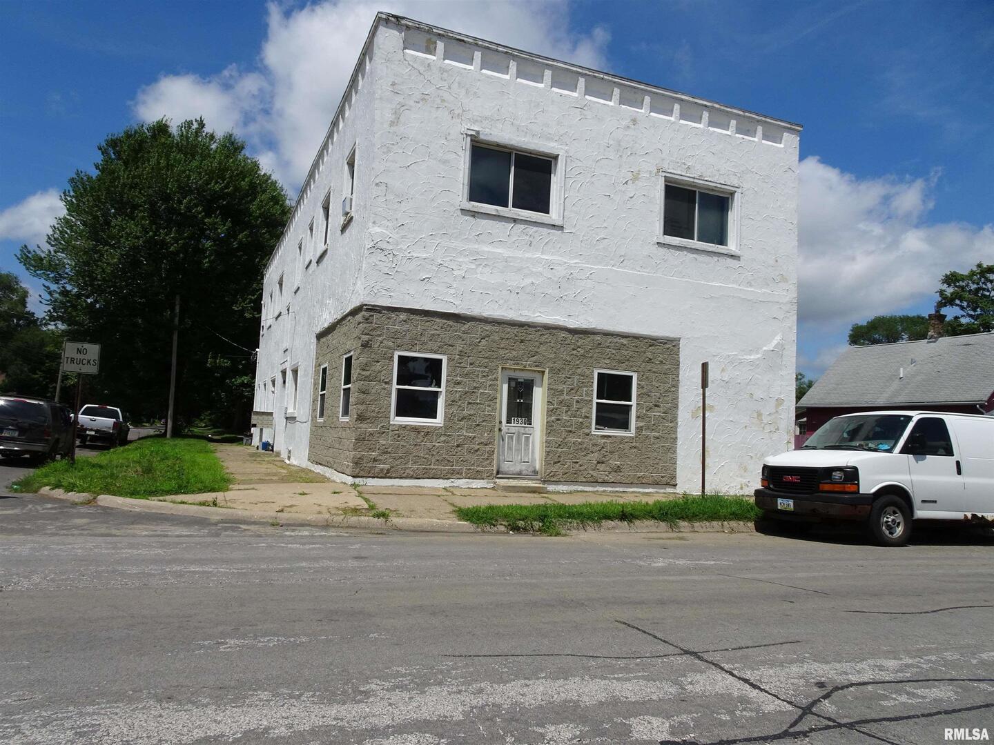 1930 9th Street Rock Island, IL 61201 - Photo 2 of 17 a front view of a house with a yard and garage