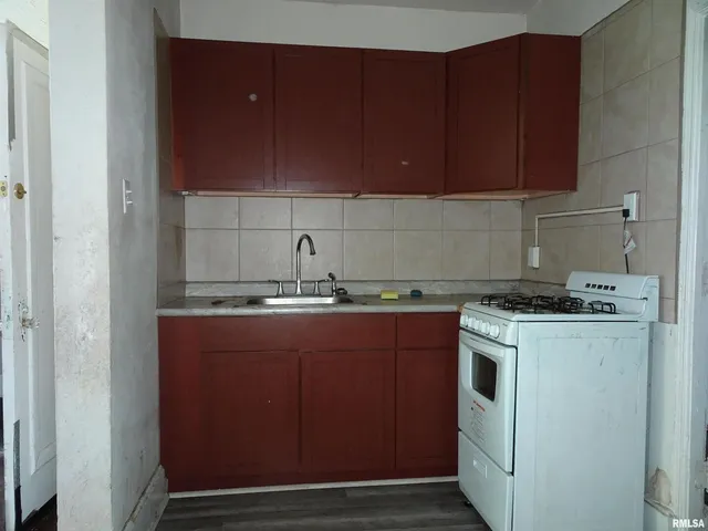 a kitchen with a cabinets and white stove