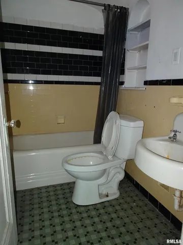 a bathroom with a toilet and a sink