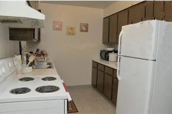a white refrigerator freezer sitting inside of a kitchen