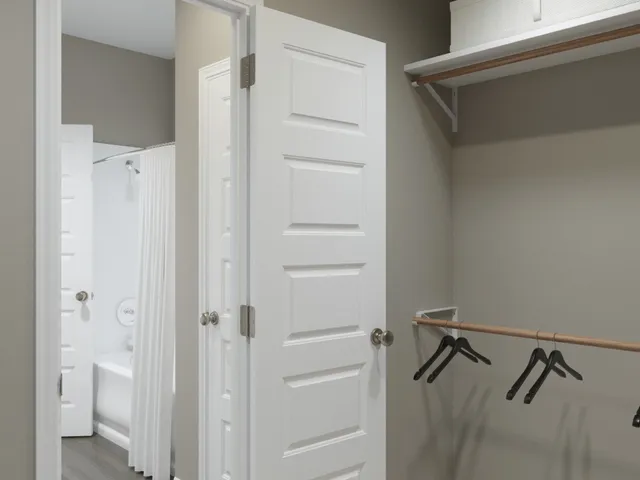 a bedroom with a bed and a mirror