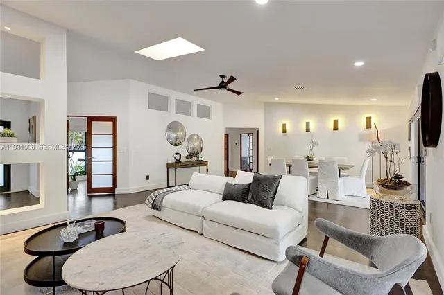 a living room with furniture large window and flat screen tv