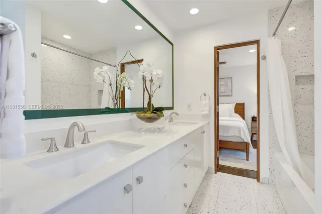 a bathroom with a double vanity sink mirror and toilet