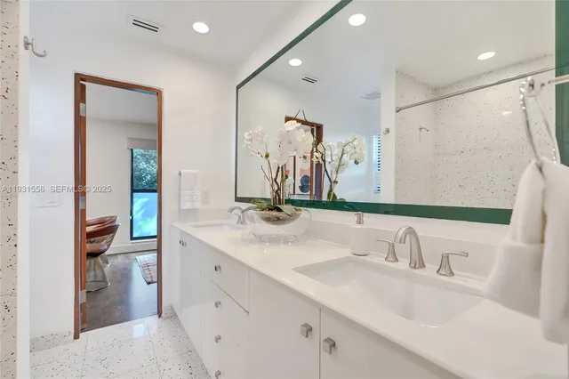 a bathroom with a double vanity sink and mirror