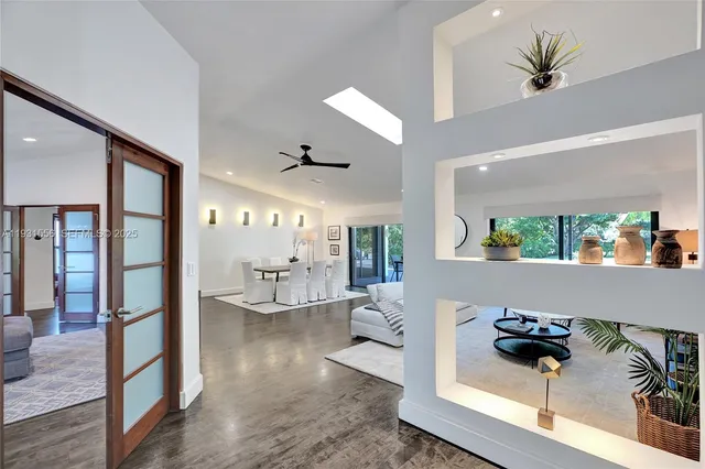 a living room with fireplace furniture and a large window