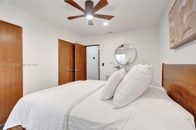 a view of a patio with table and chairs potted plants with wooden floor and floor to ceiling window