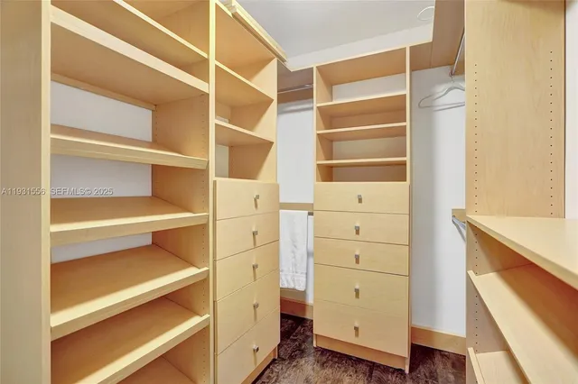 an aerial view of a house with a yard and lake view