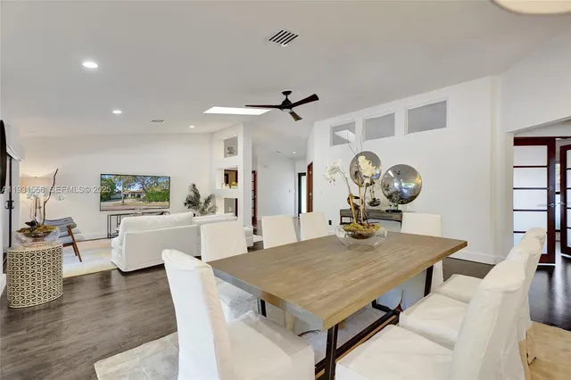 a living room with furniture a rug and a flat screen tv