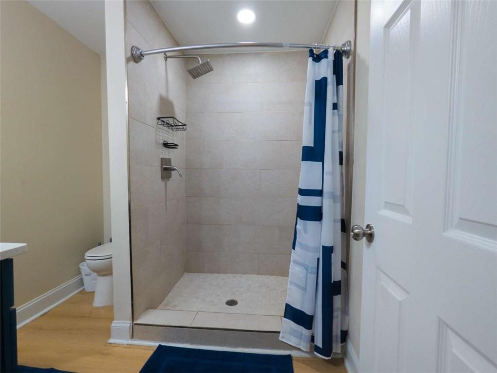 6557 Woodrow Road Lithonia, GA 30038 - Photo 12 of 17 a bathroom with a shower and toilet
