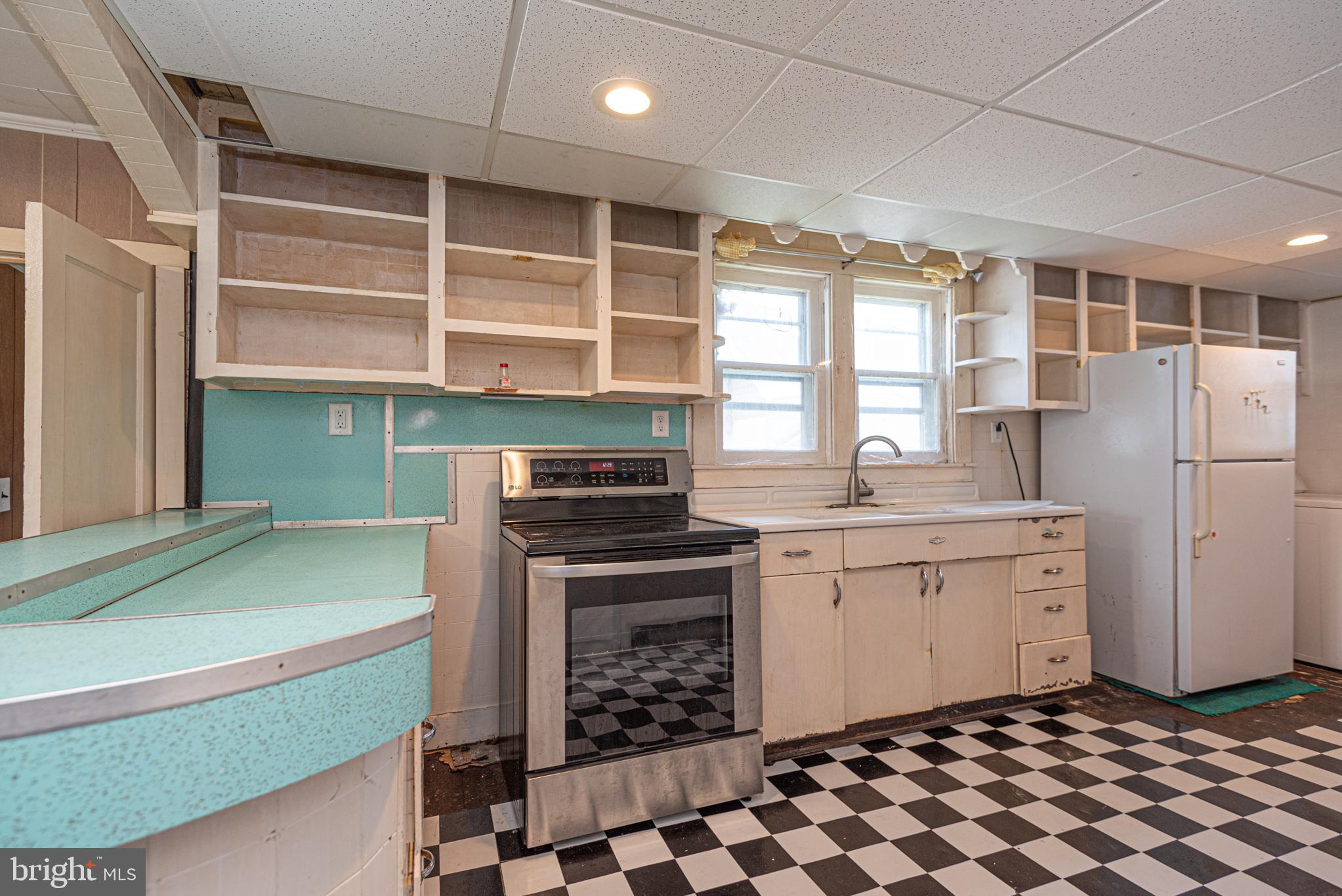 17 Burley Street Berlin, MD 21811 - Photo 142 of 150 a kitchen with a stove a sink and a refrigerator