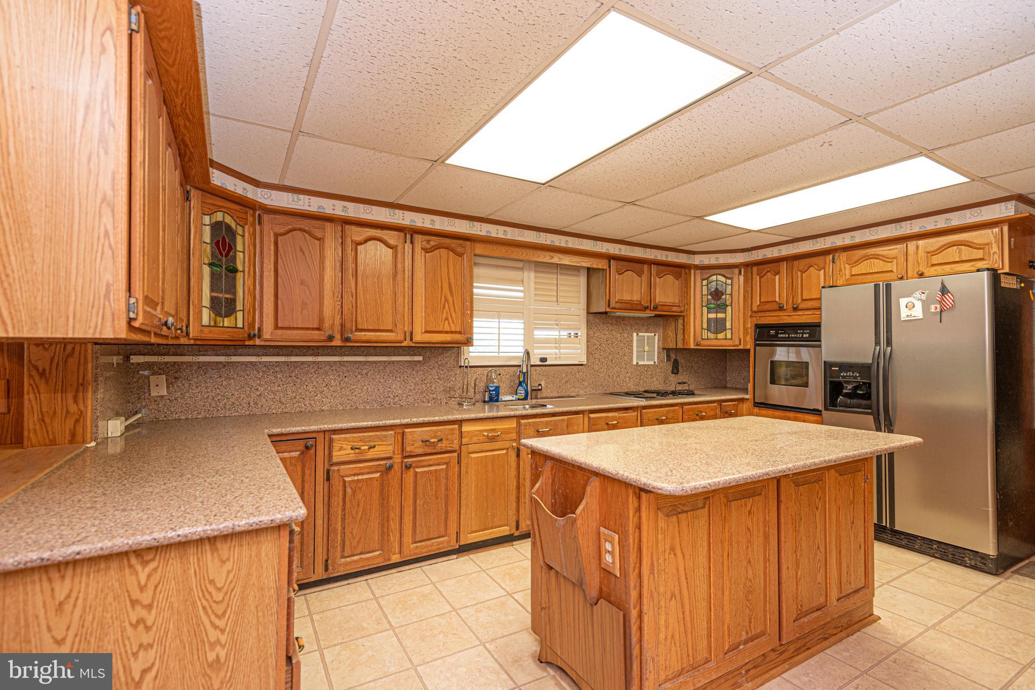 17 Burley Street Berlin, MD 21811 - Photo 16 of 150 a kitchen with stainless steel appliances granite countertop a sink counter space cabinets and a large window
