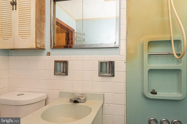 a front view of a house with a tree