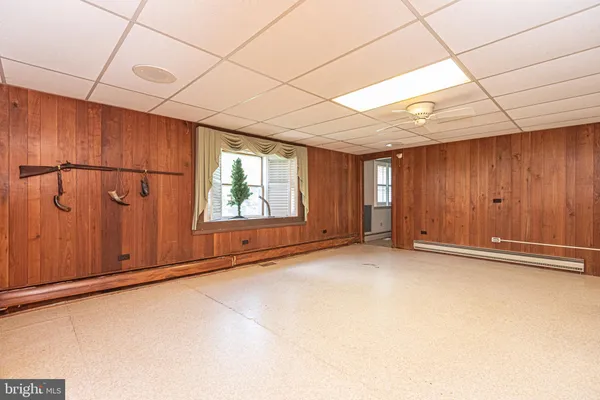 a kitchen with stainless steel appliances a sink a stove a window cabinets and a dining table