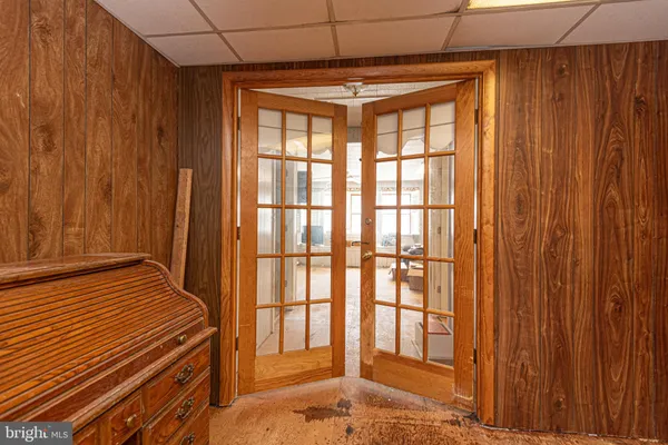 an aerial view of residential house with outdoor space and trees all around
