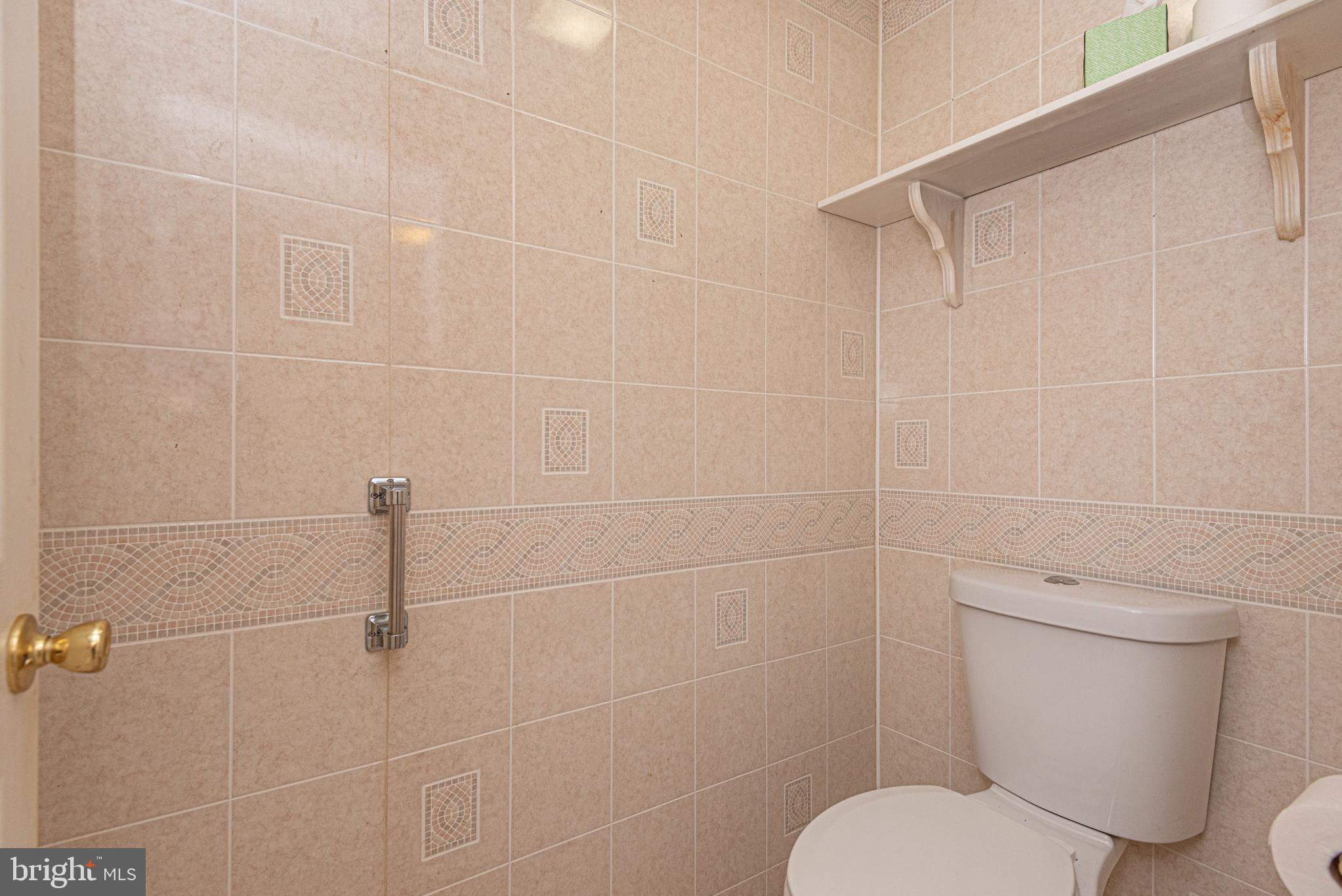 17 Burley Street Berlin, MD 21811 - Photo 43 of 150 a white toilet sitting next to a bathroom sink