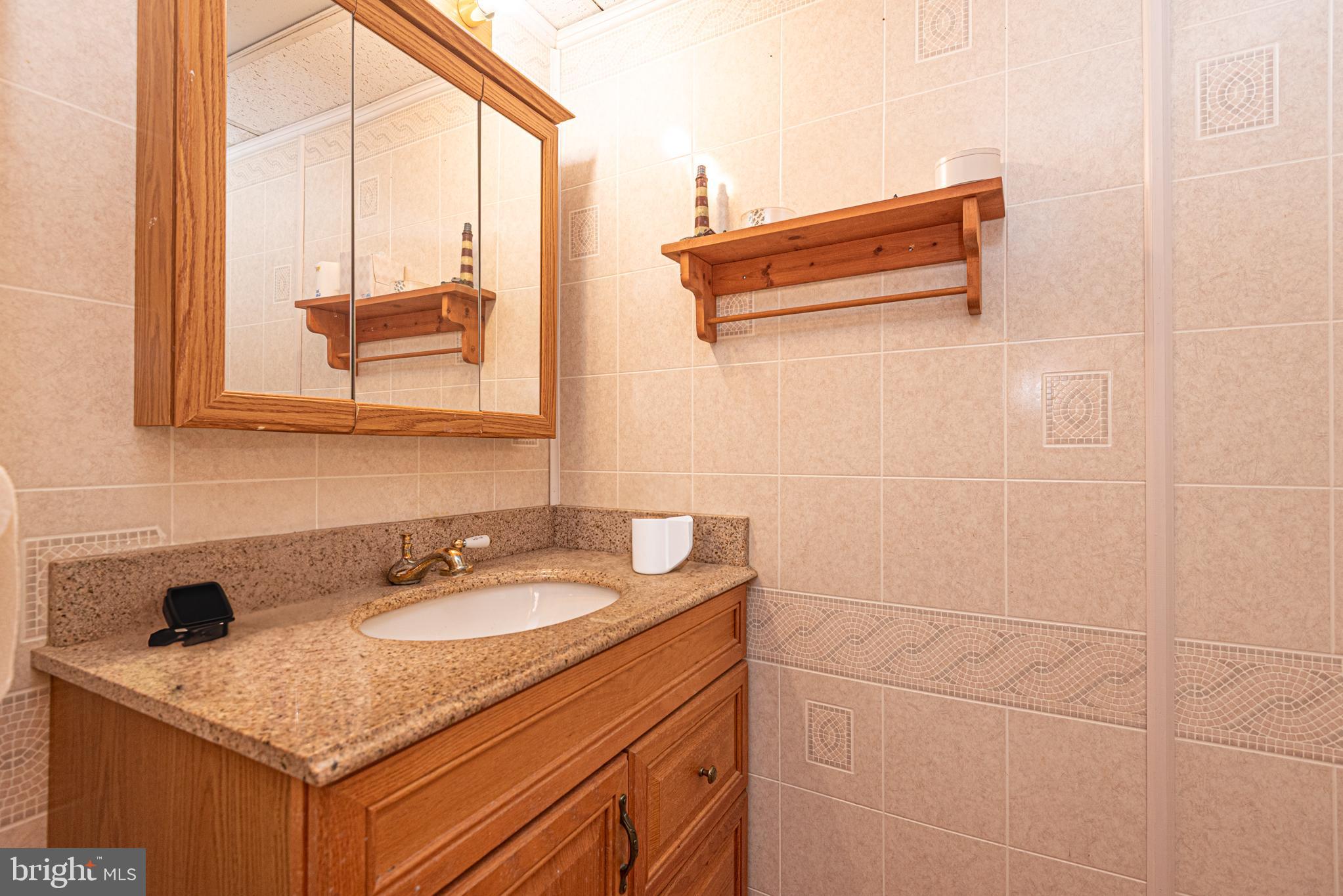 17 Burley Street Berlin, MD 21811 - Photo 47 of 150 a bathroom with a granite countertop sink and a mirror