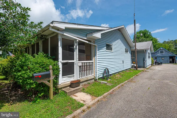wooden floor fireplace and windows in an empty room