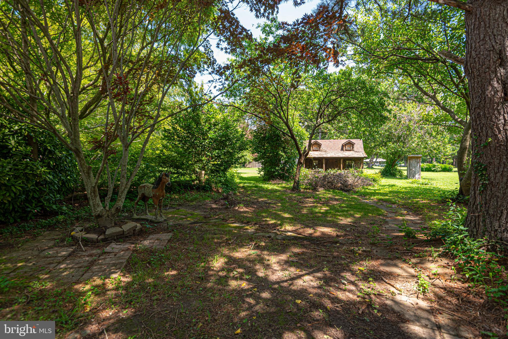 17 Burley Street Berlin, MD 21811 - Photo 66 of 150 a backyard of a house with lots of green space and fountain view