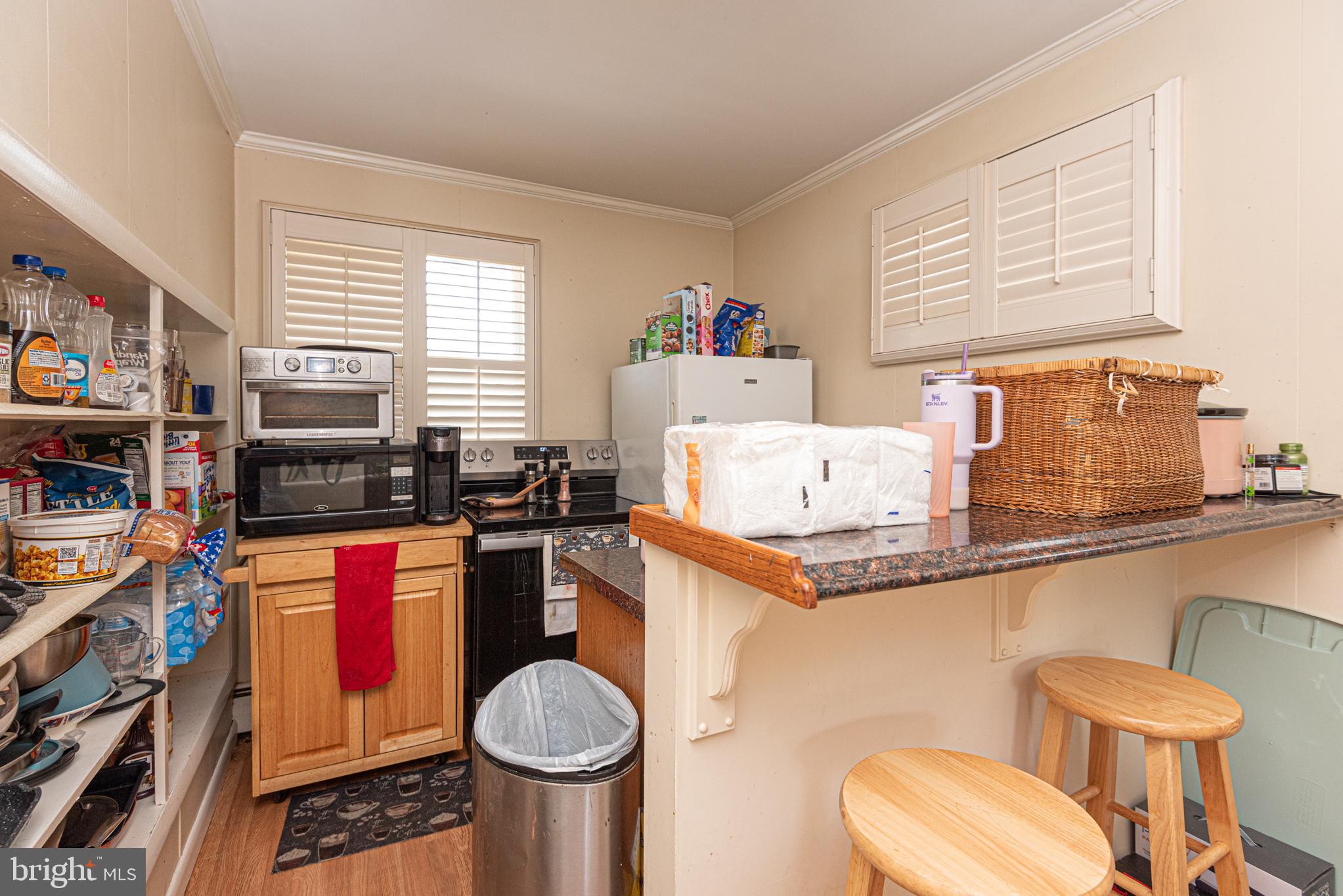 17 Burley Street Berlin, MD 21811 - Photo 80 of 150 a kitchen with stainless steel appliances a sink a stove a window cabinets and a dining table