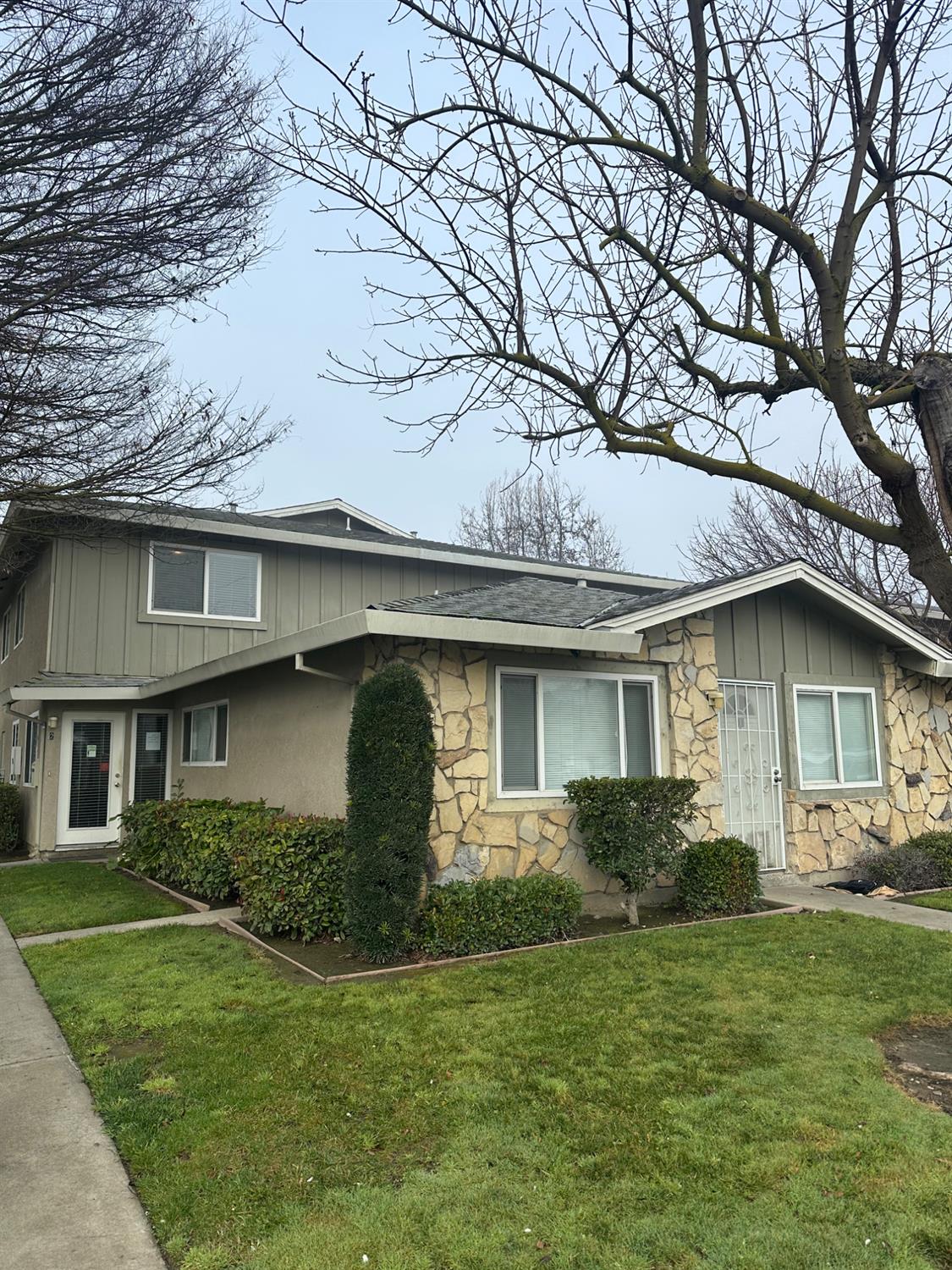 a front view of a house with a garden