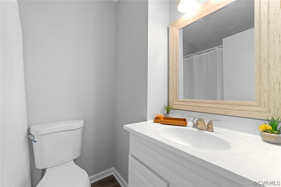 13913 Hackberry Road Chester, VA 23836 - Photo 20 of 27 a bathroom with a toilet sink and mirror